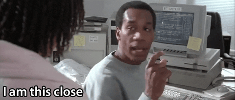 A GIF of a man saying "I am this close." in front of a computer.